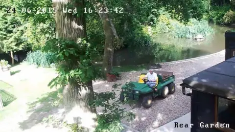 Police make renewed call over John 'Goldfinger' Palmer murder Essex Police John Palmer in a white t-shirt is driving a green ride-on lawnmower on the gravel of his garden on a sunny day. A time code on the picture reads: 24-06-2015. Wed. 16:23:42.