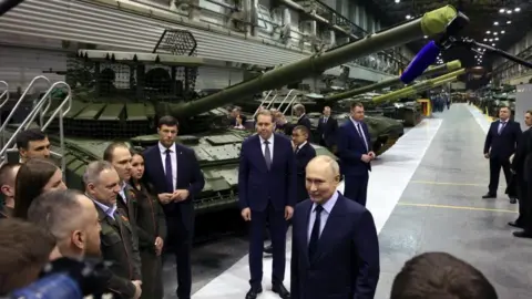 Russia's economy is down but not out Getty Images Russian President Putin visiting the country's main tank factory in the Urals