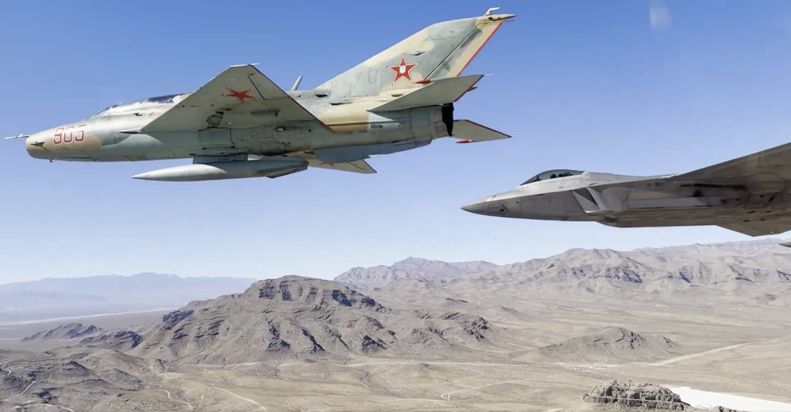 Two F-22 Raptors 'Flanked' By MiG-29, MiG-21 Fighter Jets Caught In A Very Rare Formation; What's Cooking? USAF Two F-22 Raptors 'Flanked' By MiG-29, MiG-21 Fighter Jets Caught In A Very Rare Formation; What's Cooking?