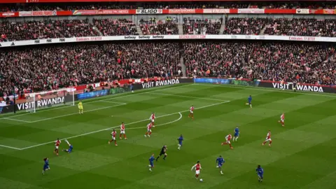 Ticket touts employing workers to bulk-buy for concerts Getty Images A wide view of players on the pitch for the Arsenal v Chelsea match.