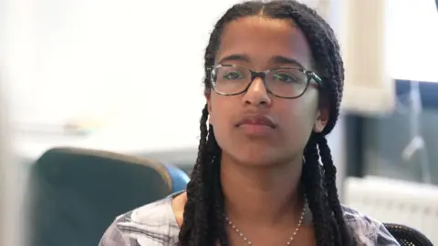 'Child Q case made me fear could this happen to me' Alyssia, 17, is wearing glasses and has long braids. She is sitting at a table taking part in a discussion