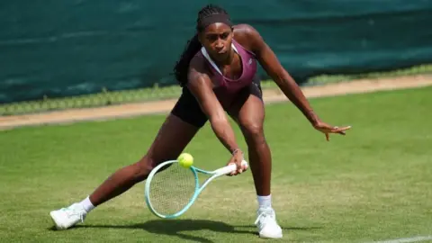 Health alerts come into force ahead of second heatwave PA Media Tennis player Coco Gauff is seen hitting a ball with an underhand during a practice session ahead of Wimbledon, as the sun shines on her