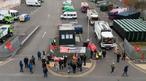 Birmingham bin strike could last until December after union vote PA Media An aerial view of people standing outside the metal gates of a bin lorry depot. There are signs hung up on the fences and some people are in orange fluorescent clothing. On the right hand side there are two white bin lorries waiting to leave the depot, but people are blocking their way