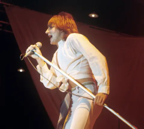 'I wish they wouldn't call it the tea time slot' PA Media Rod Stewart holds a microphone stand and sings, in a picture taken in the 1970s