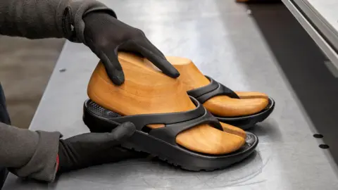 Can trainers be made in the US without cheap labour? Oka Oka flipflops being made at its factory in Georgia