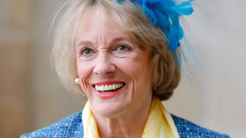 Esther Rantzen urges Lords not to block bill Getty Images Dame Esther Rantzen, an elderly woman with a short blonde bob, wears a blue feathered fascinator, a blue jacket and a yellow scarf