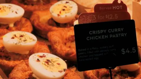 The Korean bakery that wants to make croissants less French Photo of a crispy curry chicken pastry in a Paris Baguette branch in Singapore.