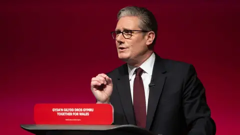 Sir Keir Starmer says fixing welfare system is a 'moral imperative' Getty Images UK Prime Minister Sir Keir Starmer speaks at a lectern in front of a red Labour background.