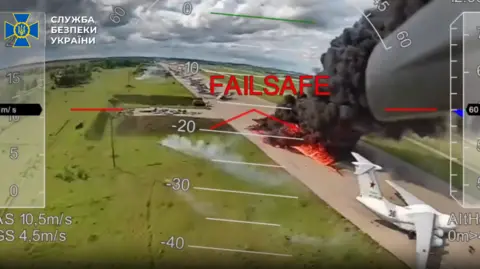 Are the surprise airfield attacks a turning point for Ukraine? SBU A screengrab of some of the drone footage released by Ukrainian authorities on Wednesday showing a plane in flames at an airfield in Russia