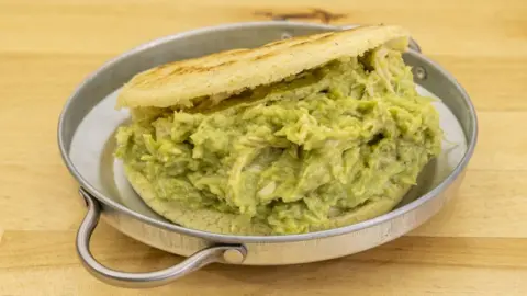 Japanese fruit sando hits high streets Tomas Llamas Quintas/Getty Images A photo of an arepa, made with yellow corn flour bread, served with a green avocado and chicken mix inside
