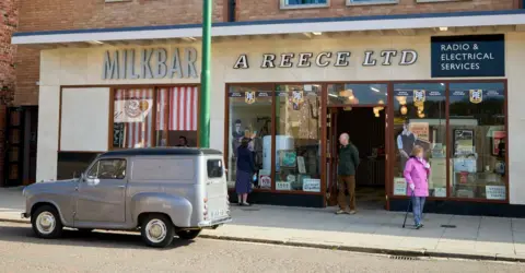 Open-air attraction in County Durham wins Museum of the Year David Levene A milk bar and electrical shop at Beamish museum, with visitors pictured on the pavement outside