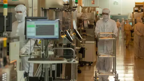 Spending Review to include £86bn for science and tech Getty Images Scientists in white protective clothing are seen working among computers and large machines.