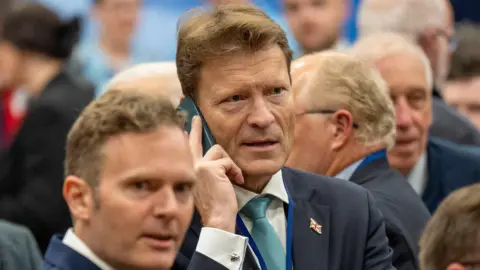 SNP to "learn lessons" as Labour wins crucial by-election PA Media Richard Tice speaking on a phone while waiting for the result