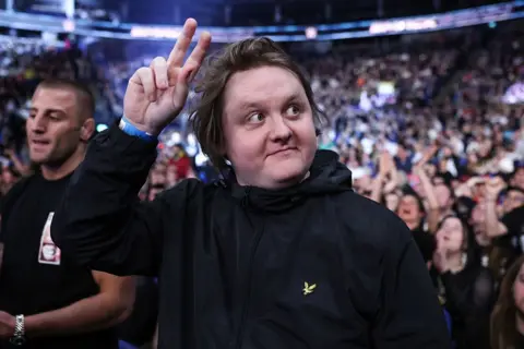 The 1975, Alanis Morissette and more to star on first day of music Getty Images Lewis Capaldi gesturing to a crowd with one hand in the air
