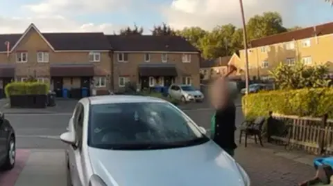 A neighbour threatened dad with a knife Supplied Doorbell footage of Melissa's car being hit with a hammer