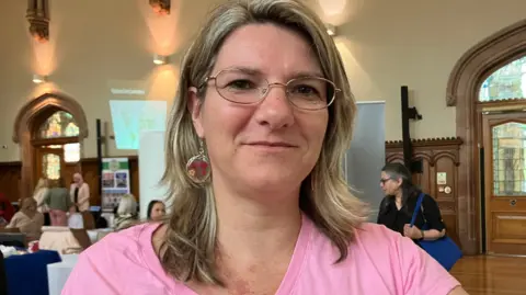 Twenty-nine arrests over recent violence A woman with blonde hair, earrings and a pink t-shirt. She wears glasses.