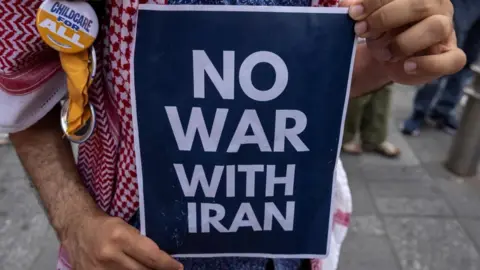 What are the worst-case scenarios? Reuters A demonstrator holds an anti-war sign during a protest against Israeli strikes on Iran