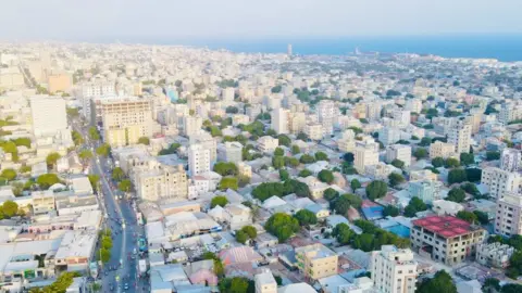 Somalia's construction boom in Mogadishu gives women high ambitions Mohamud Abdisamad / BBC A view from up high of Mogadishu showing a main road and lots of new multi-storey buildings and the sea seen on the horizon