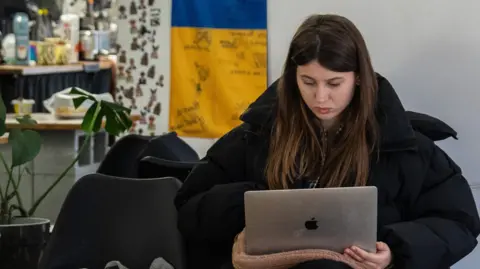 Why it has one of the most digital governments Getty Images A woman works at her laptop in a cafe in Ukraine