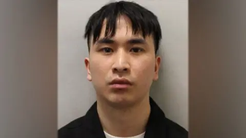 PhD student Zhenhao Zou, who raped 10 women, jailed for 24 years Met Police Police mugshot of Zou, looking impassively at the camera