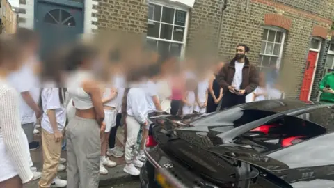 British man charged over mock Disneyland wedding to child had been investigated by BBC Parent handout Jhaj appeared outside dance auditions in 2024