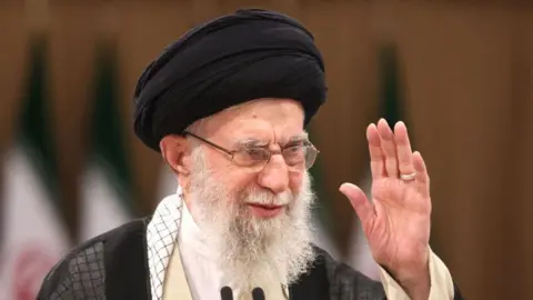 What is the Strait of Hormuz and why does it matter? Getty Images Iran's Supreme Leader Ayatollah Ali Khamenei with one hand raised