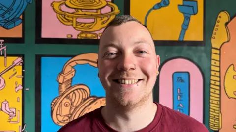 Fans and musicians share memories of Sheffield's The Leadmill A man smiling at the camera with very short hair and wearing a red shirt