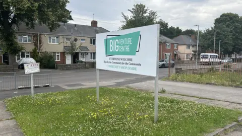 Big Venture Centre stepping in where 'everyone is struggling' A sign for the Big Venture Centre. There is a grassy area behind with daffodils. We can also see a residential road with some houses in the background.