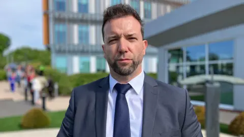 Talbot Green police station attacker jailed for attempted murder Detective Superintendent Andrew Williams from Counter Terrorism Policing Wales is wearing a grey suit with a navy tie and looking straight at the camera.