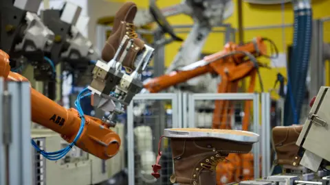 Can trainers be made in the US without cheap labour? Keen Boots being manufactured by robots at the company's facility in Portland, Oregon