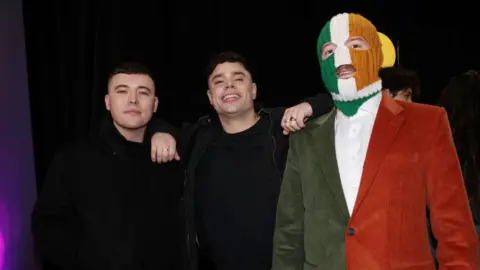 Kneecap performing at Glastonbury 'not appropriate', PM says Getty Images Kneecap members Mo Chara, Moglai Bap and DJ Provai standing together.