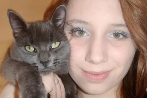NHS trust and medic guilty of failings Figueiredo family Alice, a woman with long blonde hair, poses for a photo while holding a grey cat