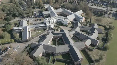 NHS trust and medic guilty of failings An aerial view of Goodmayes Hospital, Ilford, showing many white and grey rectangular buildings forming a near circle