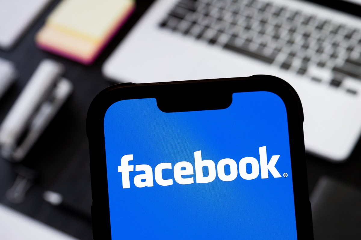 facebook logo on phone Facebook announces that all videos on its platform will soon be shared as reels
