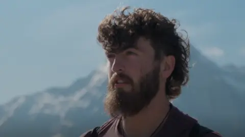 Scottish wingsuit flyer dies during Swiss Alps jump Man with beard looking out to the horizon at top of a mountain