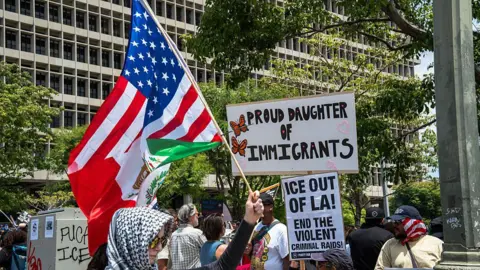 Migrant crackdown risks choking off critical supply of US workers AFP/Getty Demonstrators fill the street with signs and flags in Los Angeles, California on June 14, 2025
