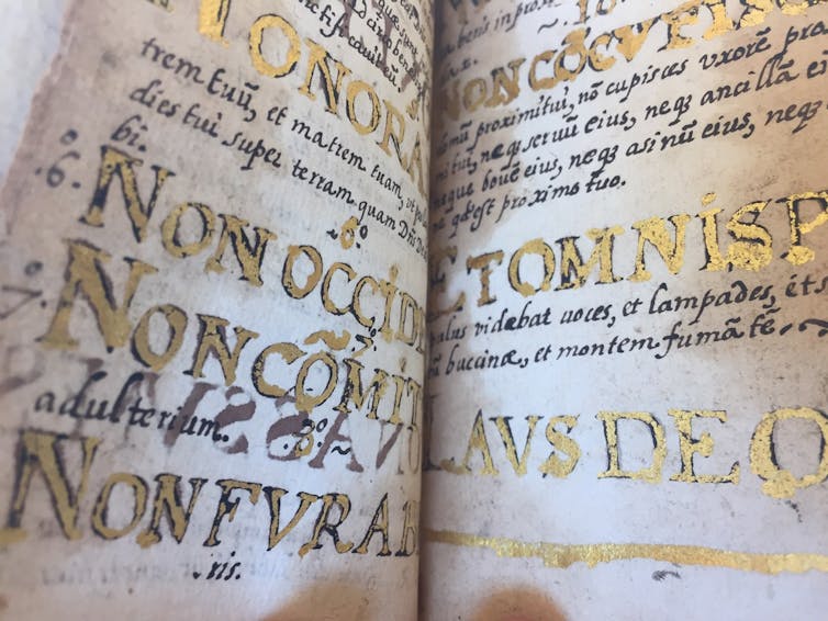 Jews were barred from Spain’s New World colonies − but that didn’t stop Jewish and converso writers from describing the Americas An open manuscript with large lettering in gold and black.