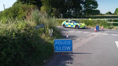 Amazon delivery driver dies as train strikes van in Teynham A police car sits still at the scene with a blue Police Slow sign