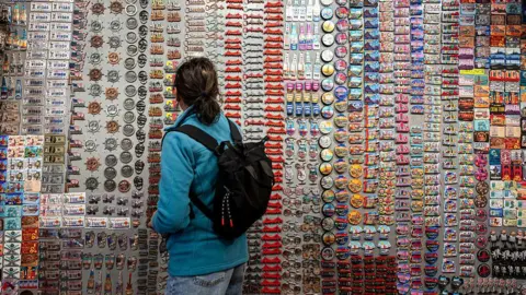 What have tariffs really done to the US economy? Bloomberg/Getty A shopper looks at magnets at a gift store in the Chinatown neighborhood of San Francisco, California, US, on Wednesday, June 25, 2025.