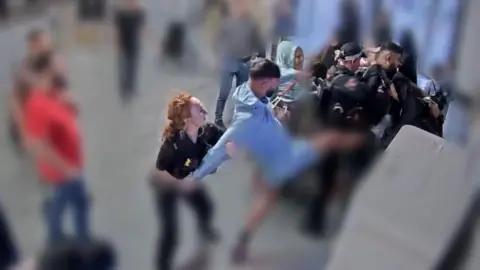 PC punched in Manchester Airport brawl 'absolutely terrified' PA Media A man in blue kicks in the direction of a police officers while a police officer with red hair holds his arms behind him at the car park pay stations at Manchester Airport.