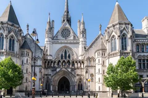 How MI5 piled falsehood on falsehood in court in the case of a spy who abused women Getty Images An exterior view of the Royal Courts of Justice where the High Court sits, with the neo-Gothic building featuring many spires, turrets, arched windows and a central rose window pictured in sunshine against blue skies.