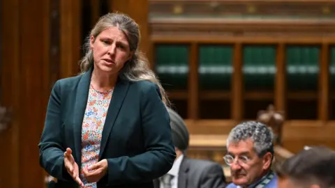 Labour suspension doesn't mean I'm silenced, MP says PA Media Rachael Maskell stands and gestures with her hand as she addresses the House of Commons. She has long, wavy blonde hair and wears a dark green jacket and a floral top.