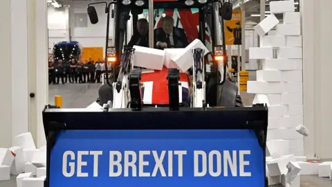 The secret of the perfect political slogan Getty Images Boris Johnson drives a JCB bulldozer emblazoned with the slogan Get Brexit Done through a stack of polystyrene bricks