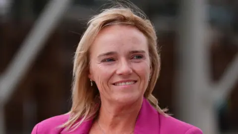 Trans changing room row nurse cleared of misconduct as tribunal resumes PA Media Sandie Peggie smiles and looks off to the side. She has shoulder length blonde hair and wears a pink blazer.