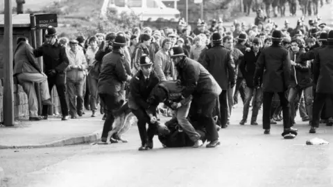 Battle of Orgreave national inquiry confirmed by Yvette Cooper Getty Images Police and miners clash at Orgreave Colliery. In the photo a man can be seen being dragged away by two police officers.