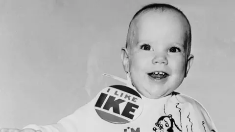 The secret of the perfect political slogan Getty Images Monochrome image of smiling baby wearing an "I like Ike" badge