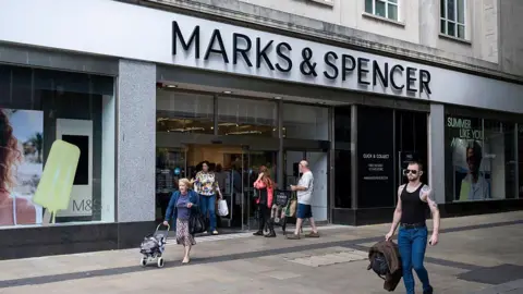 Getty Images Shoppers and people outside Marks & Spencer in Swansea