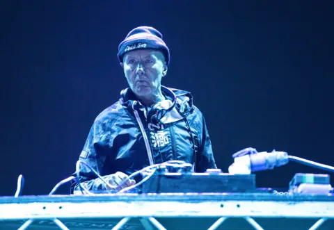 Trainspotting author Irvine Welsh says AI has made us dumbed down machines Getty Images Irvine Welsh in hat and anorak DJing during Playground Festival 2021 at Rouken Glen Park in Glasgow