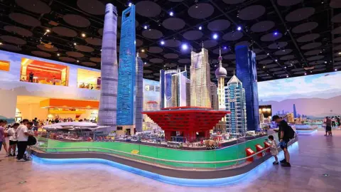 China bets on Western theme parks to lift spending Getty Images Visitors view a Lego miniature of the Shanghai skyline at the Legoland Shanghai Resort. The miniature, set up within a convention hall, stands at least six metres tall.