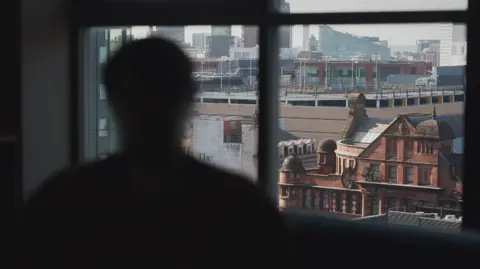 Police investigate sex abuse claims against men linked to Church A silhouette of a person looking out of a window overlooking a city centre